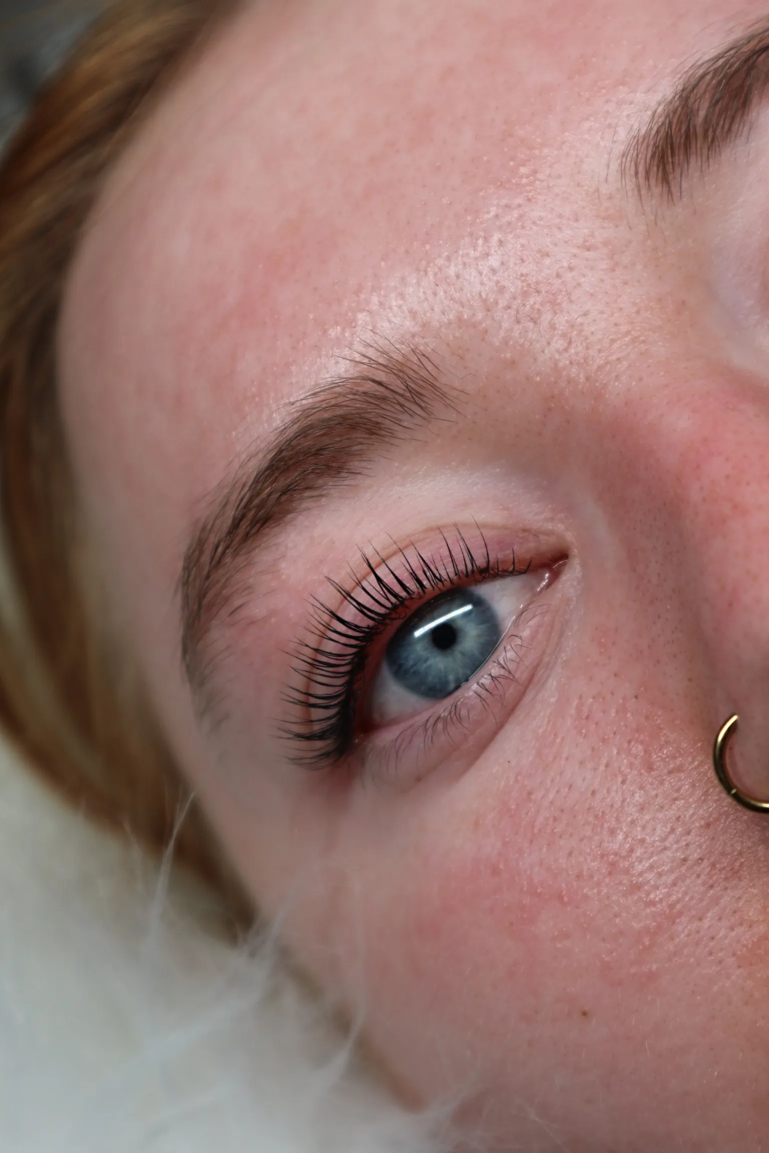 Lash lift and tint result on a pale blue eye