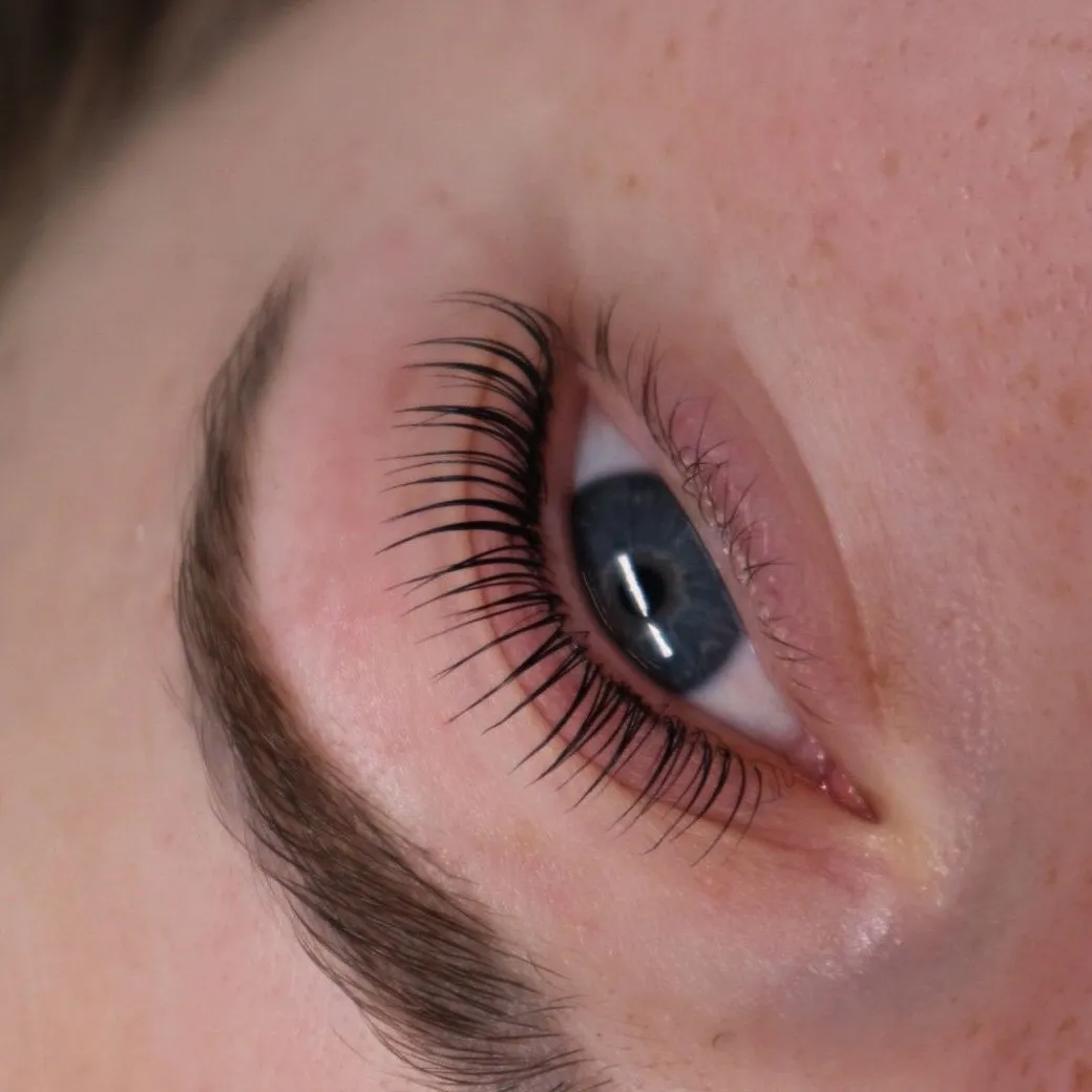 Close-up of beautifully lifted natural lashes after a Korean lash lift