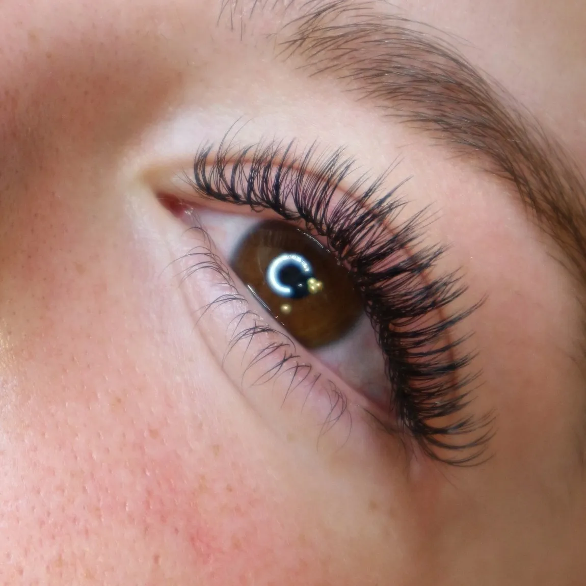 Wispy angel lash extensions on a blue eye